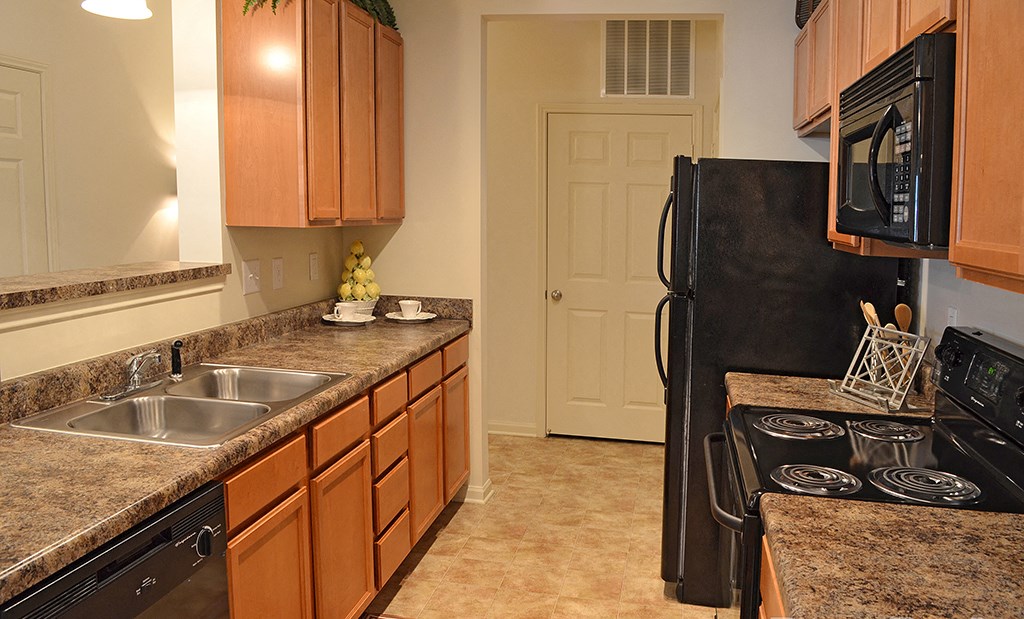 Kitchen with black appliances at the Haven at Market Street Station Aiken, SC
