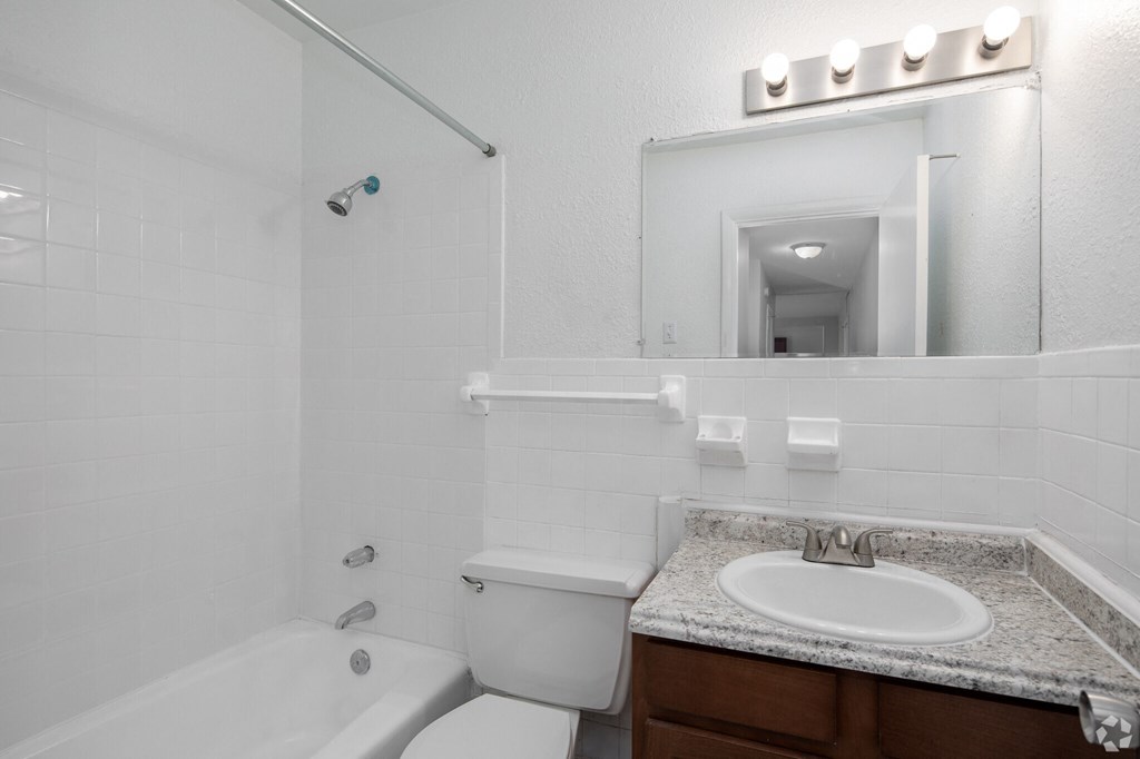 a bathroom with a sink toilet and bathtub
