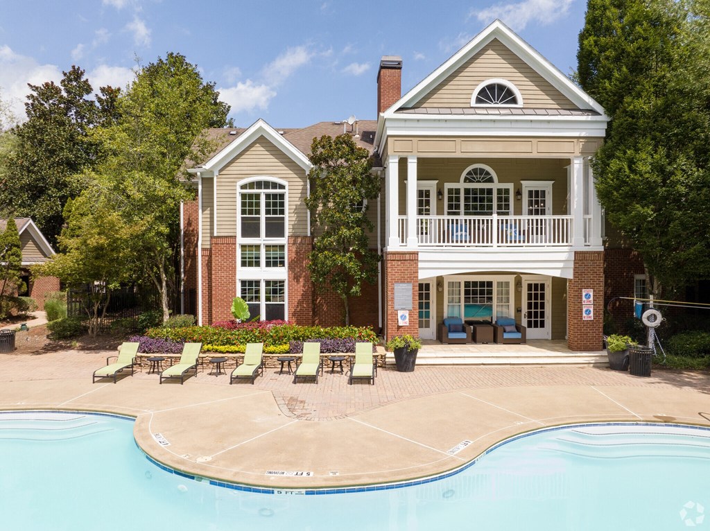 a large house with a swimming pool in front of it  at Flats at North Springs, Georgia, 30328