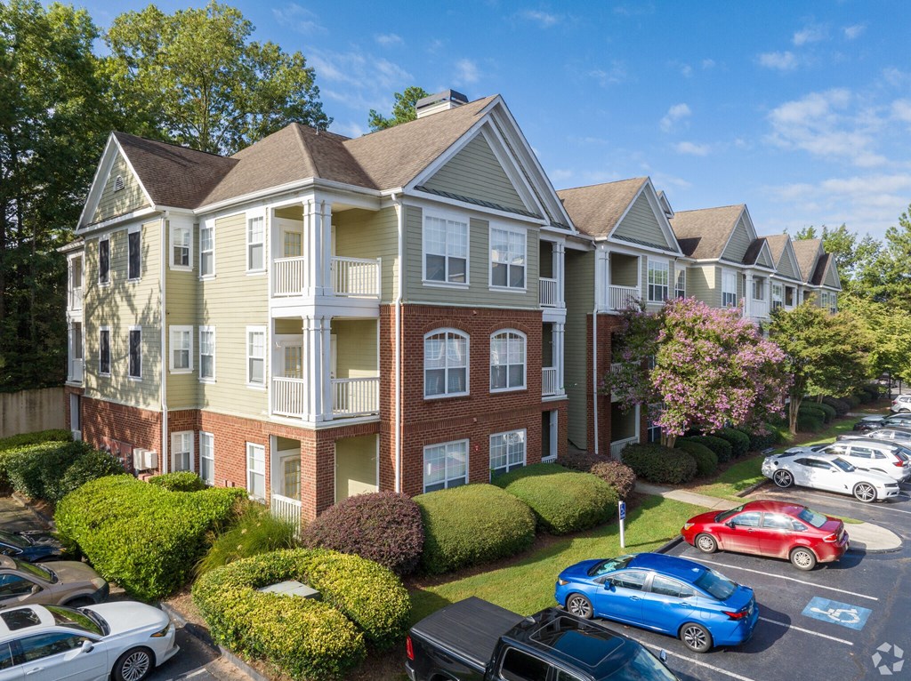 an aerial view of an apartment building with a parking lot at Flats at North Springs, Georgia