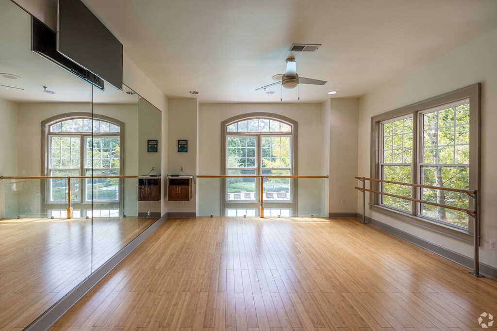 an empty living room with a hard wood floor and large windows  at Flats at North Springs, Sandy Springs, GA, 30328