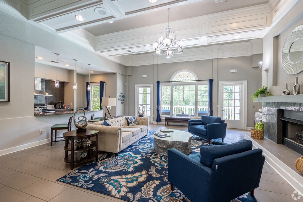a living room with couches and chairs and a fireplace  at Flats at North Springs, Georgia