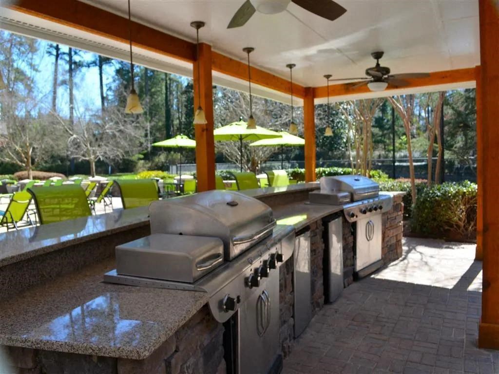 the outdoor kitchen is open to the patio at Flats at North Springs, Sandy Springs, GA, 30328