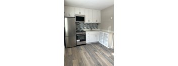 A kitchen with a stainless steel refrigerator, oven, and microwave at Briarcliff at Quechee, Vermont