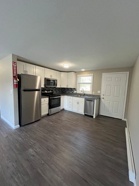A kitchen with a refrigerator, stove, and oven. at Briarcliff at Quechee, Quechee, 05059