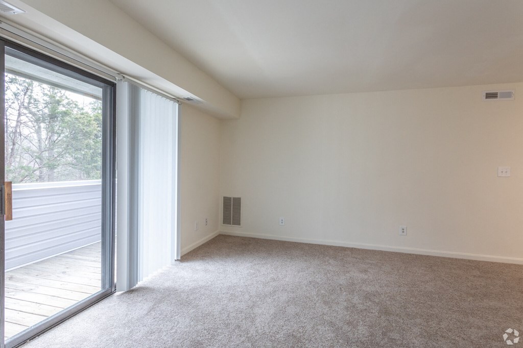 a bedroom with a sliding glass door and carpet