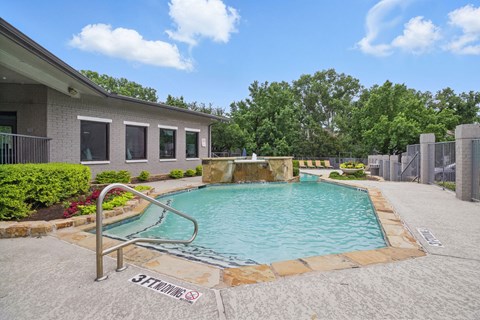 A pool with a slide in the middle of it.
