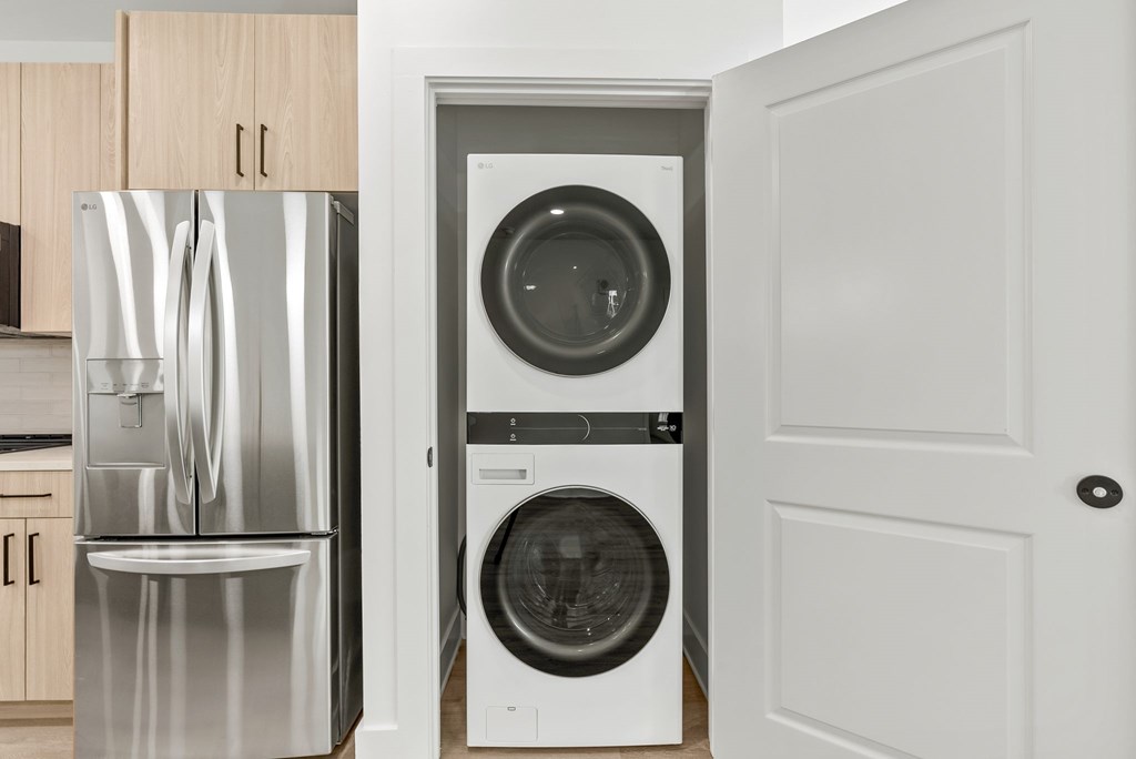 A white washing machine is in a doorway.