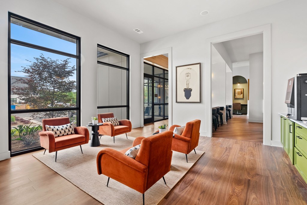 A living room with a brown sofa and a white wall.