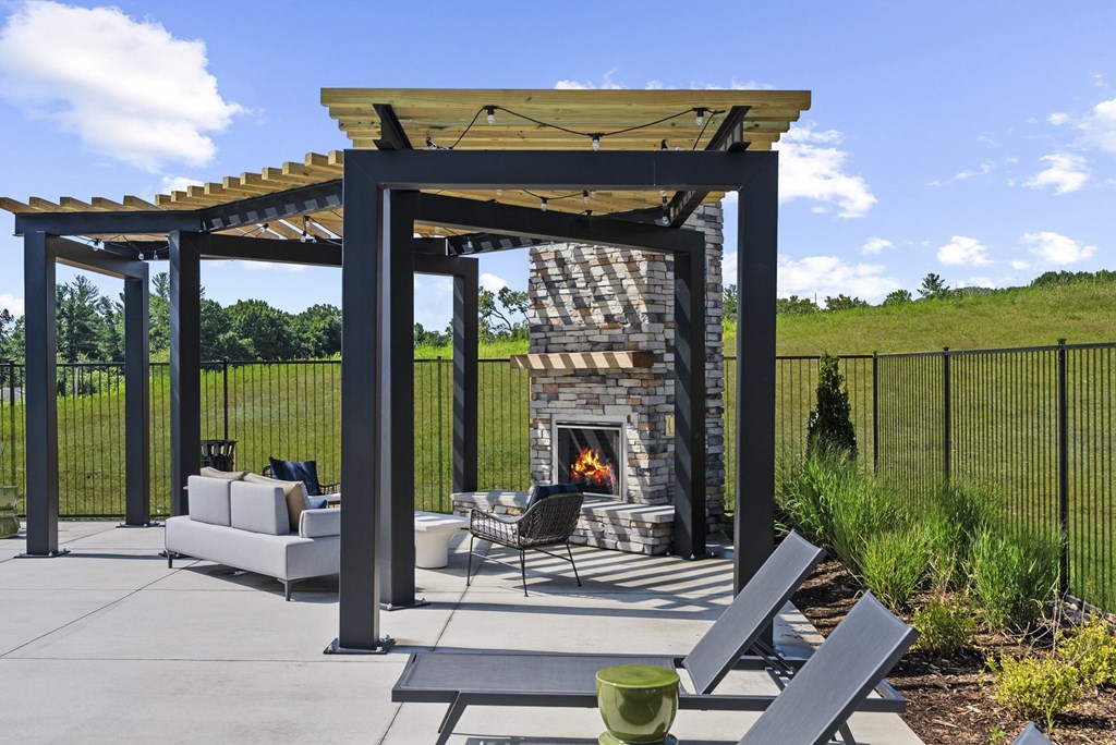 A patio with a fireplace and seating area.