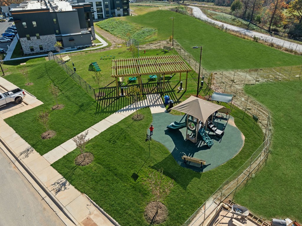 A playground with a swing set and a slide.