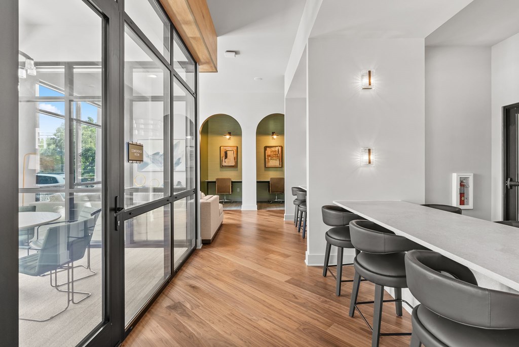 A modern kitchen with a bar area and a dining table.