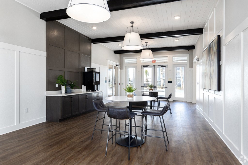 a dining room and kitchen with a table and chairs