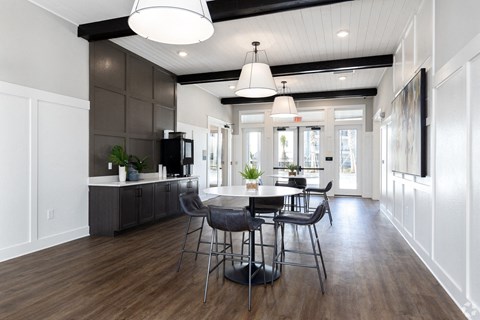 A modern kitchen with a dining table and chairs.