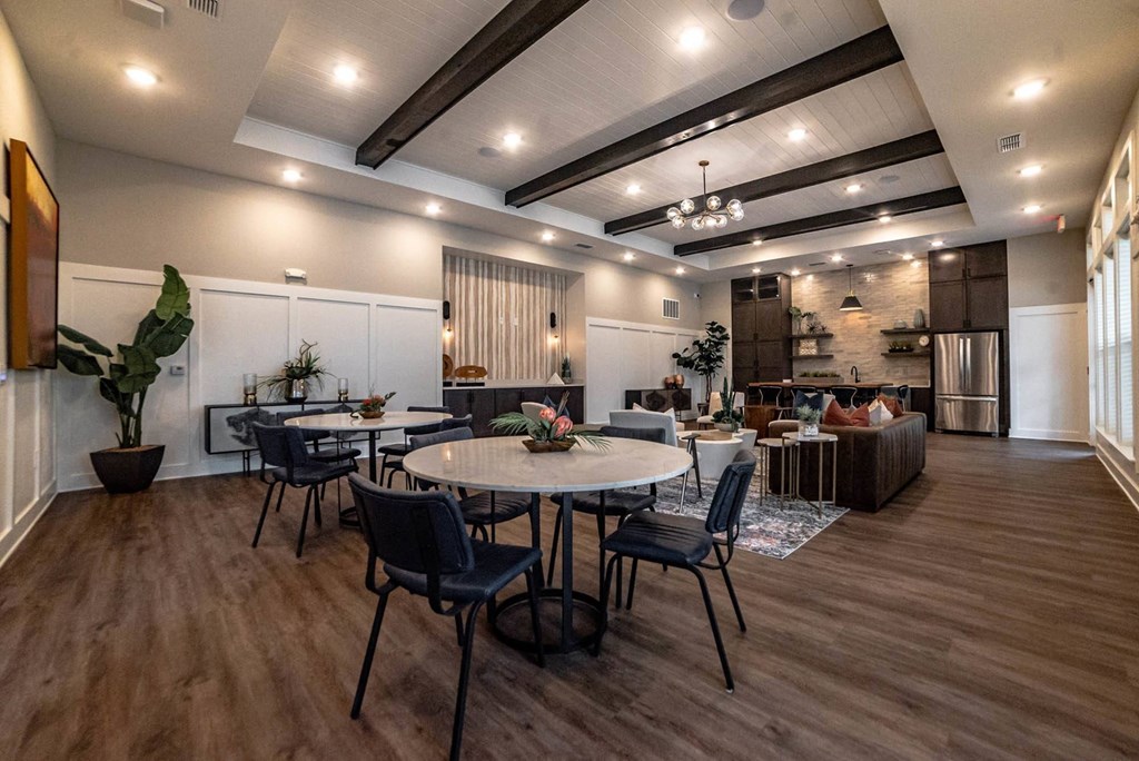 a dining room and living room with tables and chairs