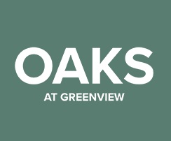 A sign that says "Oaks at Greenview" in white text on a green background.