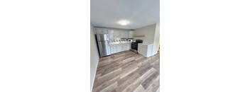 A kitchen with a refrigerator, microwave, oven, and cabinets at Briarcliff at Quechee, Quechee