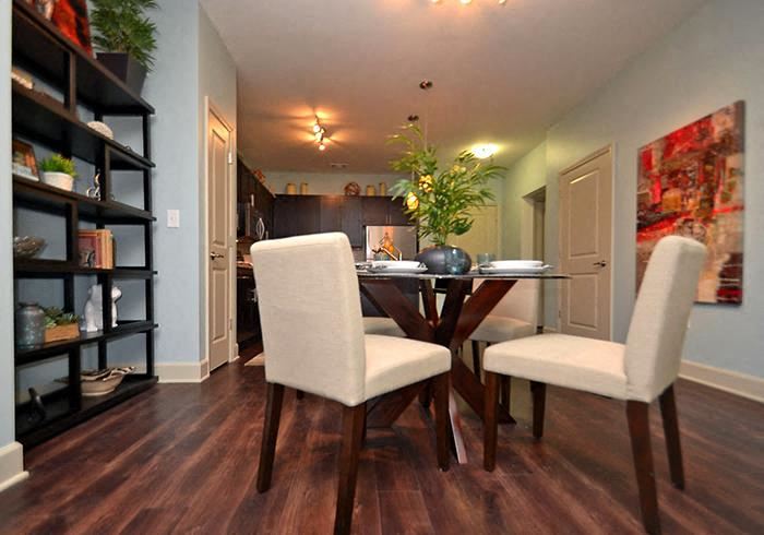 a table and chairs in a room with a bookshelf - Photo Gallery