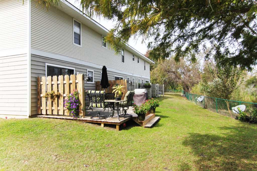 Backyard deck with greenery at Lakewood Lodge apartments, Hanahan, SC