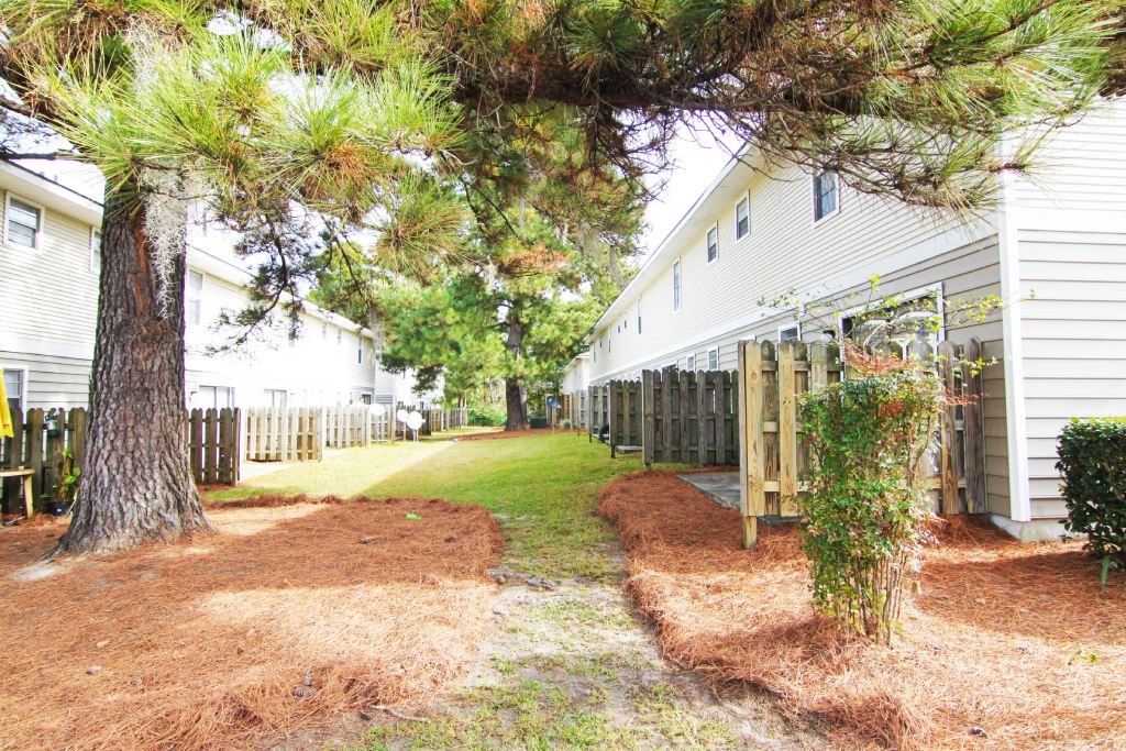 Green space with privacy fences and trees at Lakewood Lodge, Hanahan, SC