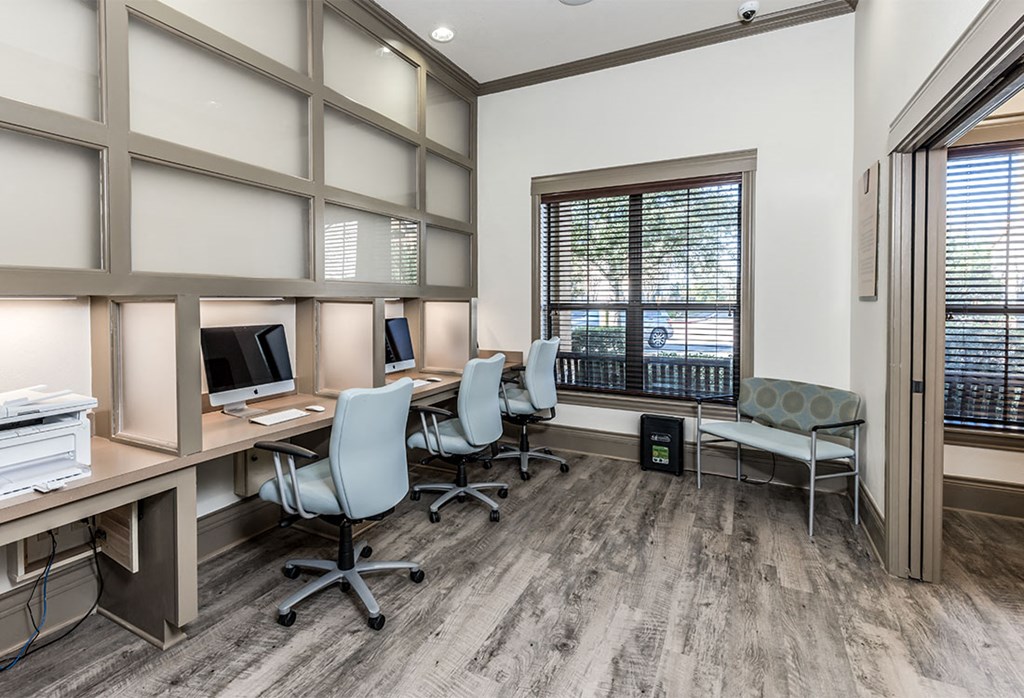 a conference room with desks and chairs and a window
