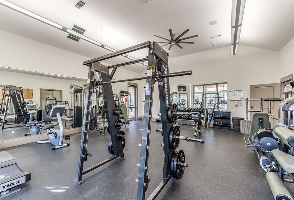a gym with weights and other exercise equipment in a building