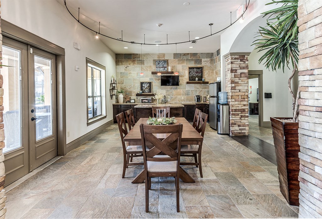 a dining room with a wooden table and chairs