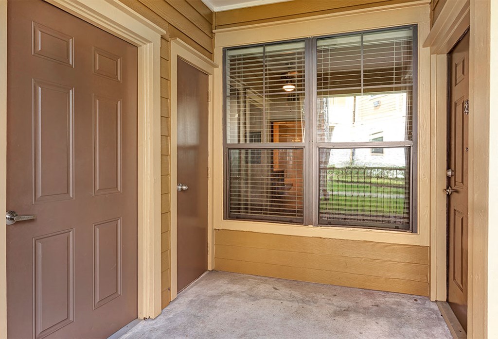a room with a large window and a door