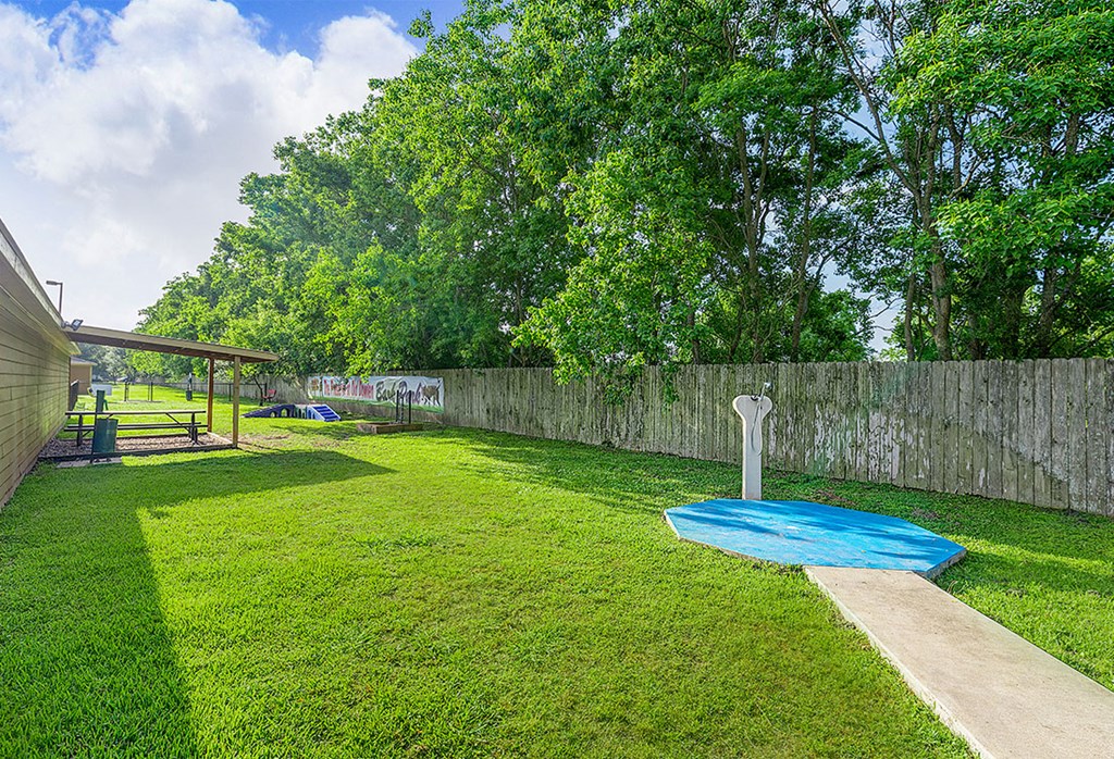 a backyard with a swing set and a blue pool