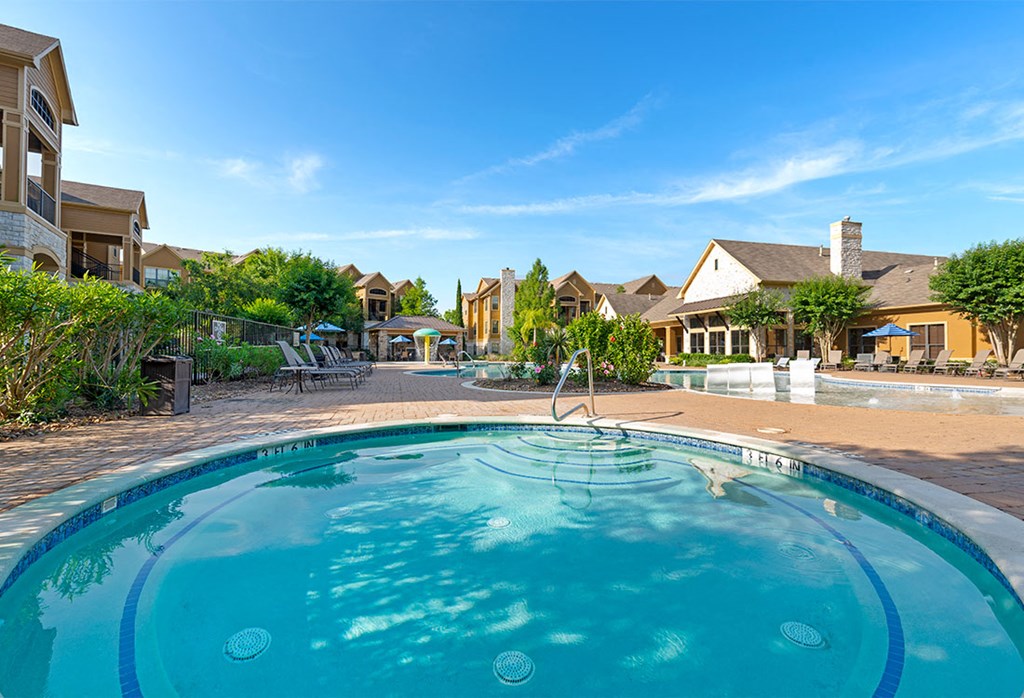 a swimming pool with houses in the background