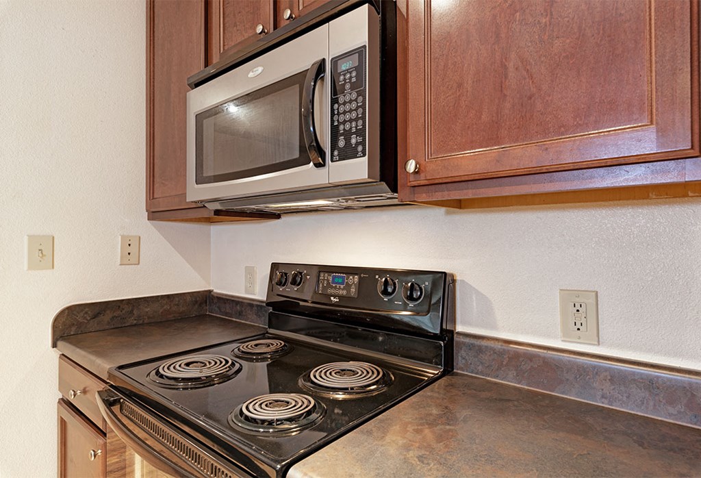 a kitchen with a stove and a microwave