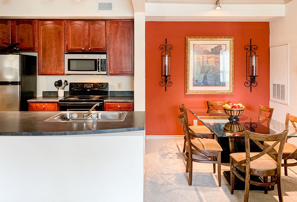a kitchen and a dining room with a table