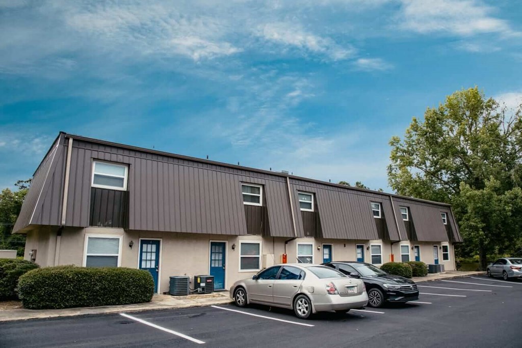 a building with cars parked in a parking lot