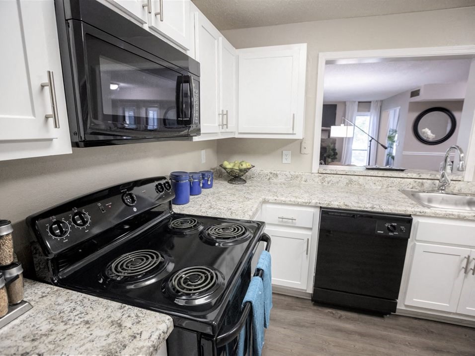 Kitchen with black appliances  at Avenues at Holcomb Bridge, Peachtree Corners, GA, 30092