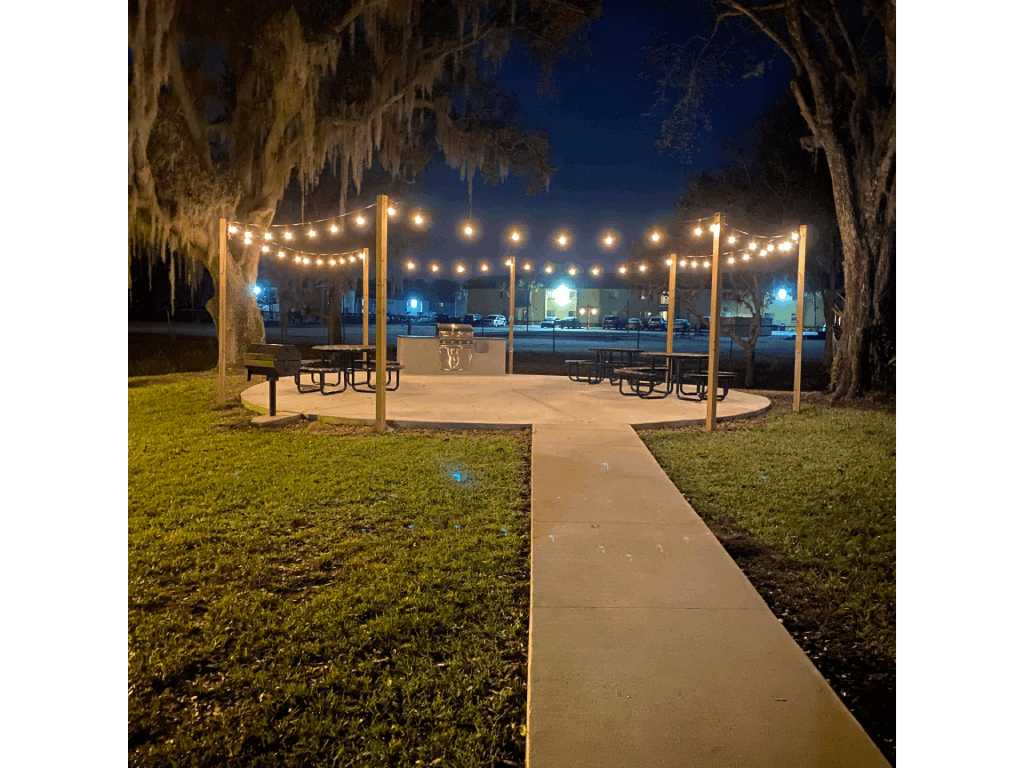 a park with benches and lights at night at Waters Edge Apartments, Florida, 33803