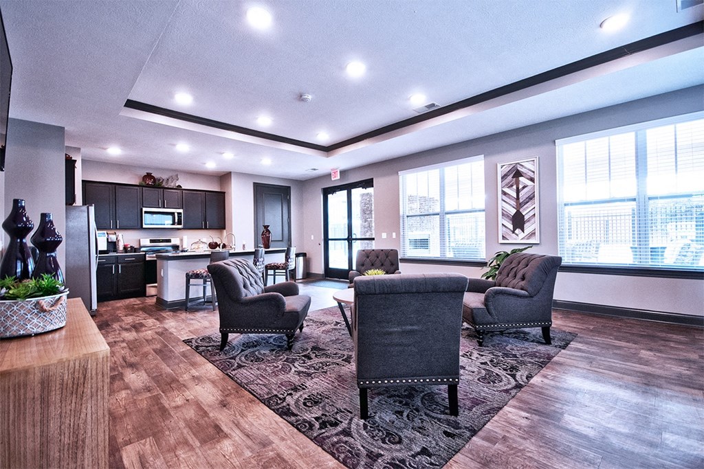 a resident clubhouse with couches chairs and a kitchenette at Park 33, Goshen