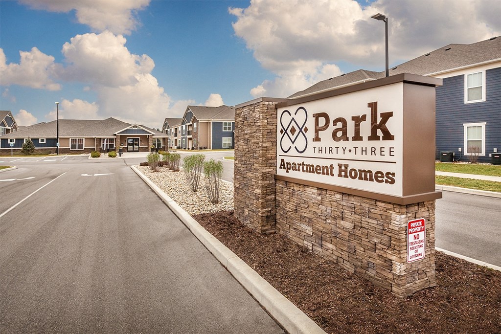 a sign for the park at hayward apartments with houses in the background at Park 33, Goshen Indiana