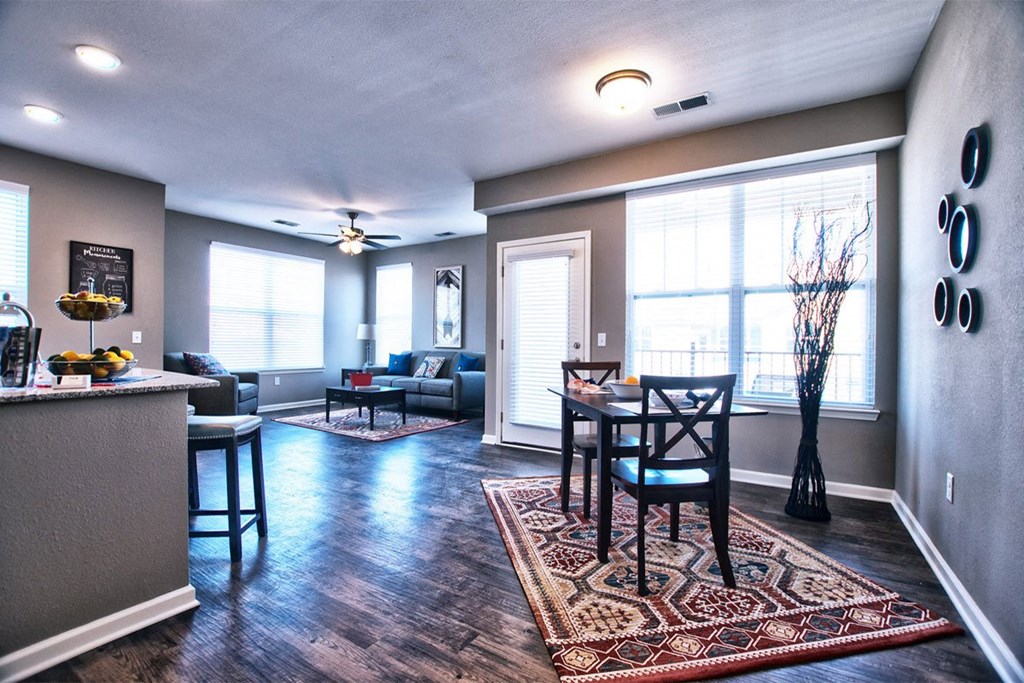 a living room with a table and chairs in front of a window at Park 33, Goshen, IN