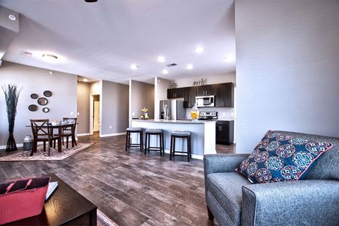 a spacious living room with a kitchen and dining area at Park 33, Goshen, IN 46526