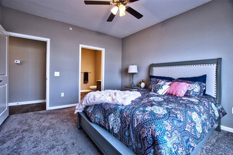 a bedroom with a bed and a ceiling fan a bedroom with a bed and a ceiling fan at Park 33, Goshen, IN 46526