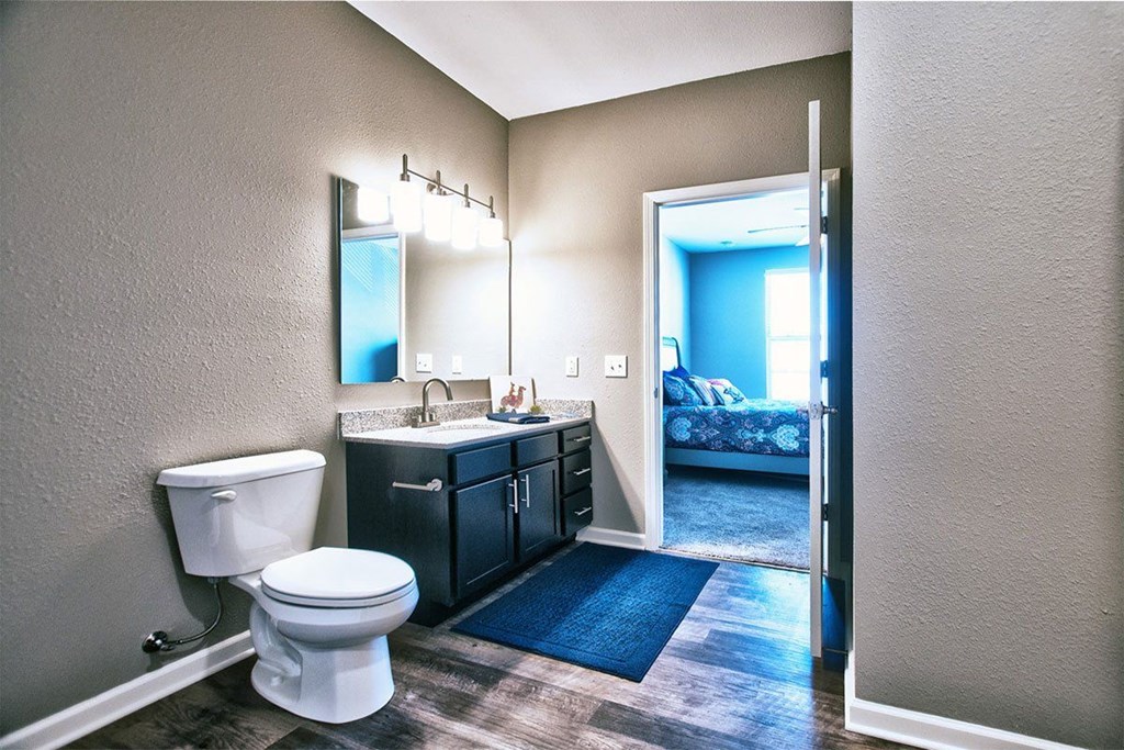 a bathroom with a toilet sink and mirror at Park 33, Goshen