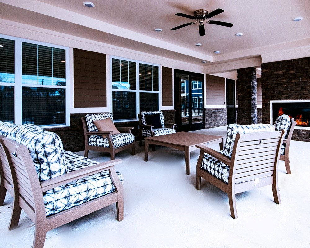 a patio with a fire place and a bunch of chairs at Park 33, Goshen, IN