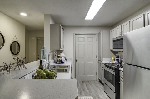 a kitchen with stainless steel appliances and white cabinets