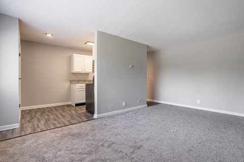 A spacious room with a washer and dryer in the corner.