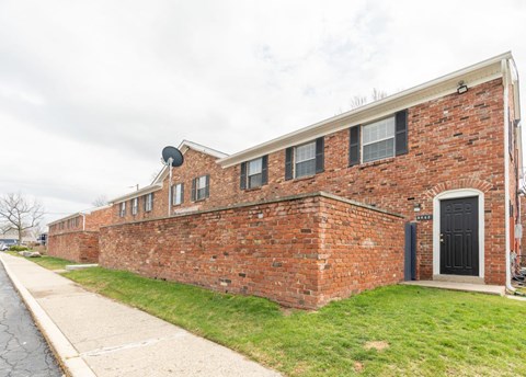 the side of a brick building with a black door