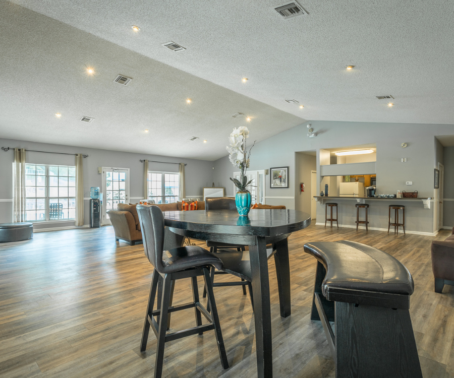 a dining room and living room with a table and chairs