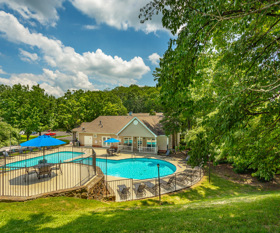 our apartments have a large swimming pool and a patio with tables