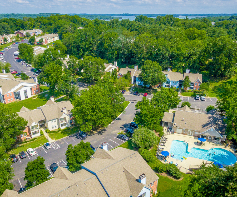 a aerial view of a neighborhood of houses and a swimming pool