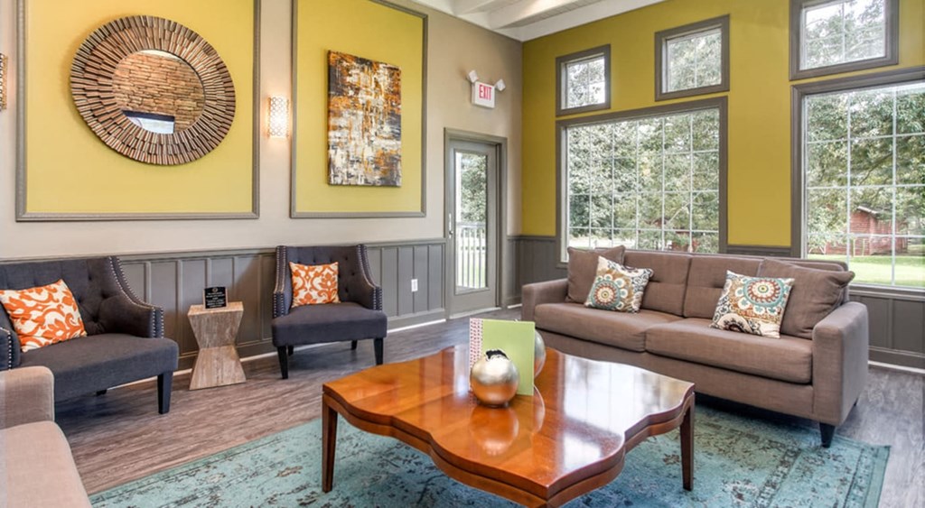 a living room with couches and chairs and a coffee table