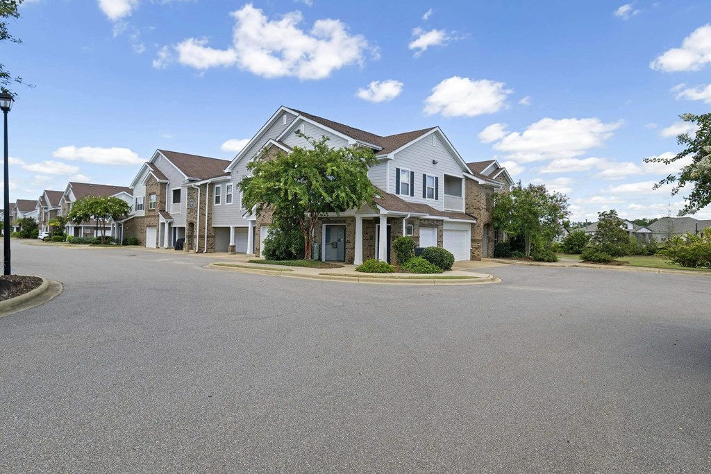 an empty street in front of a row of houses at Century HomePlace, Alabama